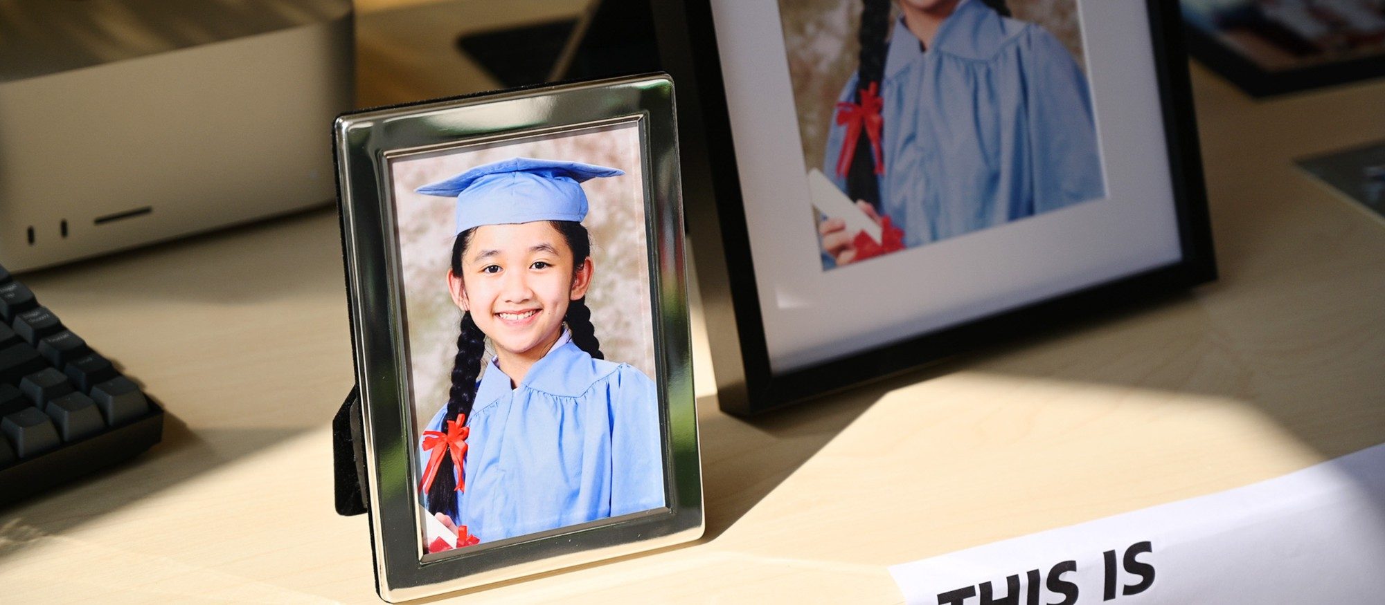 Framed graduation portrait on a desk